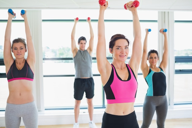 Premium Photo | Women lifitng weights in fitness studio