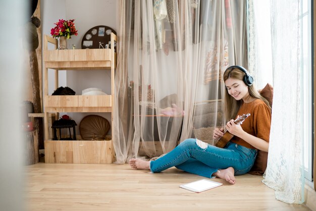 Girl Plays Guitar In Living Room