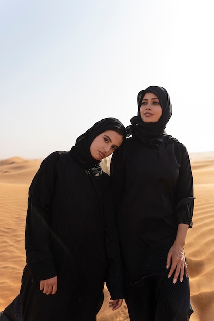 Premium Photo | Women wearing hijab in the desert