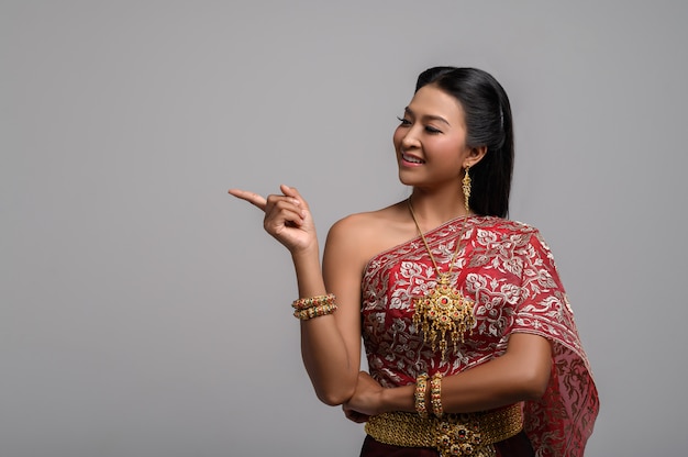 Women wearing thai costumes that are symbolic, pointing fingers Free Photo