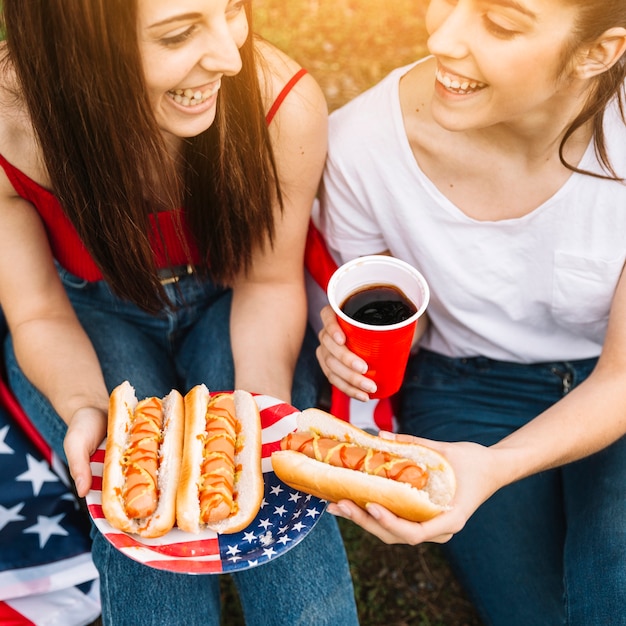 Premium Photo | Women with hot-dogs outside