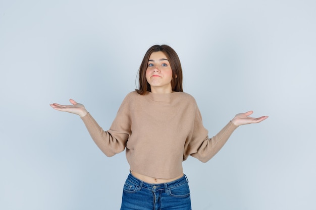 Premium Photo Wonderful Lady In Sweater Jeans Shrugging Shoulders And Looking Hesitant