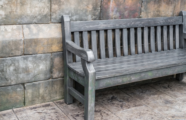 Wood bench against concrete wall . Free Photo