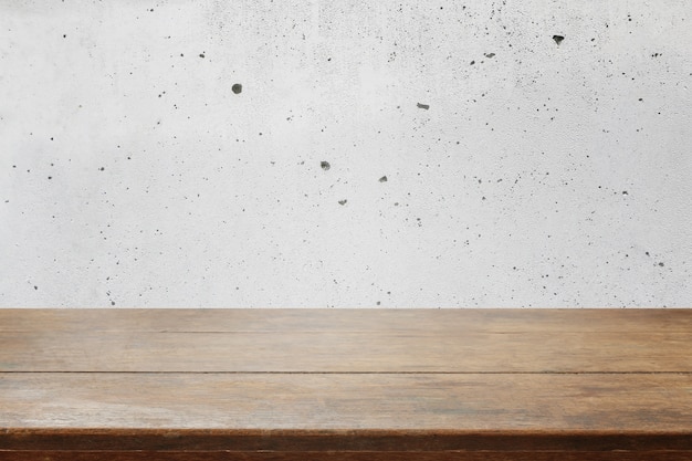 木製テーブルトップとコンクリート壁の背景 プレミアム写真