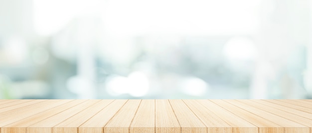 Wood table top on  with blur glass window wall background. Premium Photo