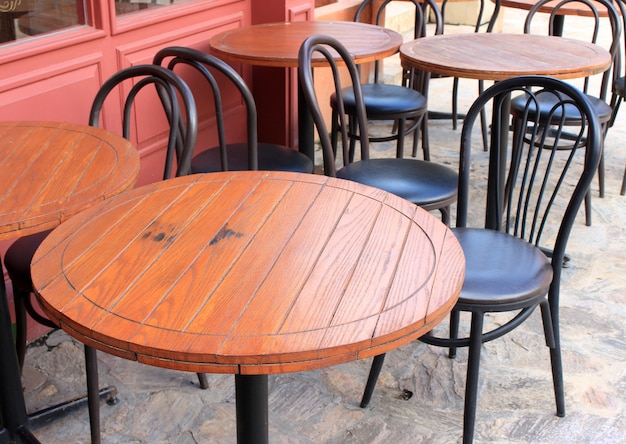 Premium Photo Wood Tables And Black Chairs Set Up For Lunch Outside Cafe