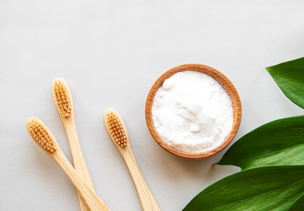 Premium Photo | Wooden bamboo eco friendly toothbrushes, baking soda on  white background. dental care and zero waste concept