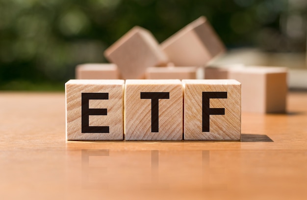 Premium Photo | Wooden blocks with etf lettering on desk