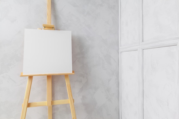 Premium Photo | Wooden easel in the room