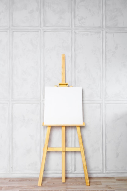 Premium Photo | Wooden easel in the room