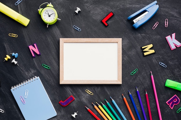 Wooden frame next to stationery and letters Free Photo