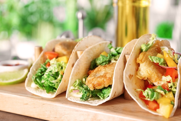 Premium Photo Wooden Holder With Yummy Fish Tacos On Kitchen Table