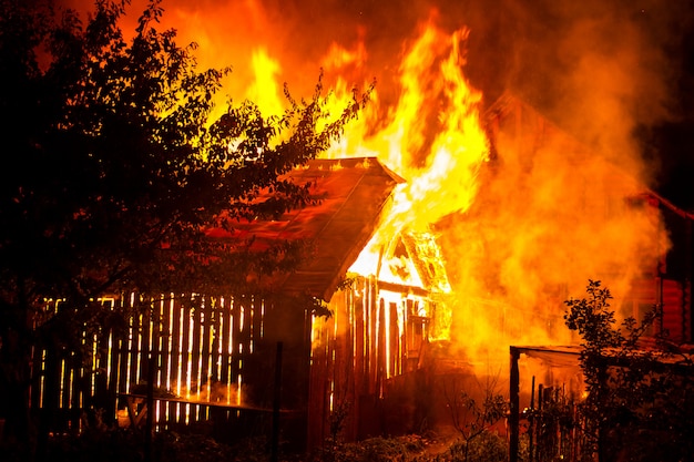 Wooden House Or Barn Burning On Fire At Night Premium Photo