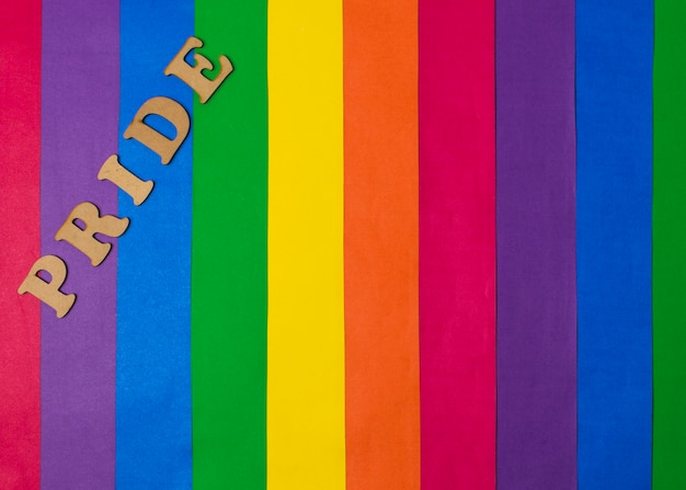 Wooden pride word and bright gay flag Free Photo