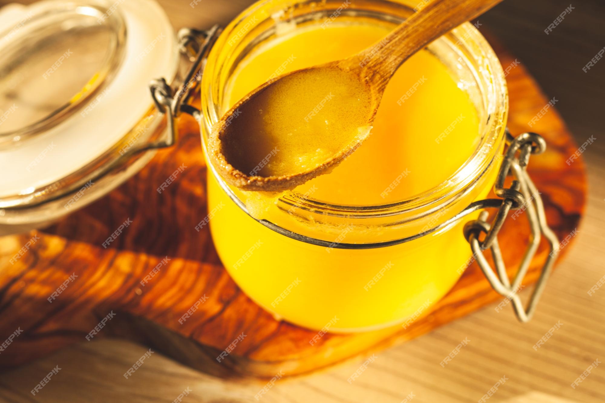 Premium Photo | Wooden spoon with ghee - clarified butter in the glass ...