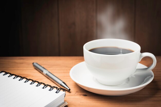 Premium Photo | Wooden table desk with coffee. workspace with note book ...