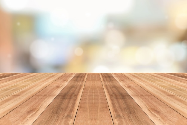 Wooden table top against blurred cafe background | Premium Photo