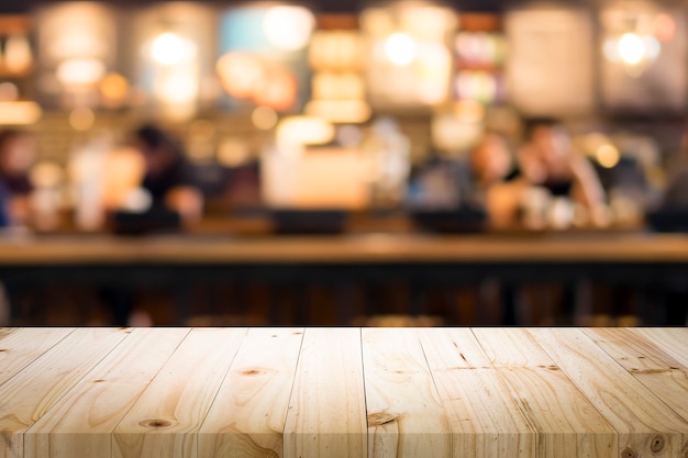 Premium Photo | Wooden table with blur background of coffee shop.
