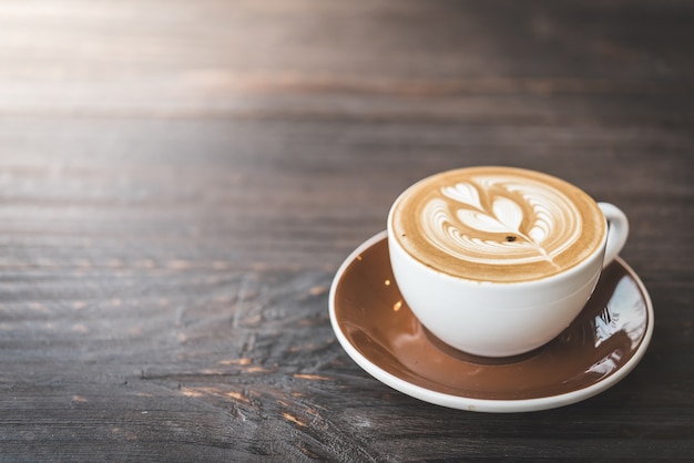 Wooden table with a cup of coffee Free Photo