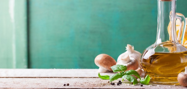 Wooden table with oil and mushrooms