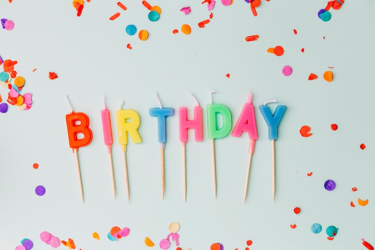 Free Photo | Word birthday candles surrounded with confetti on blue ...