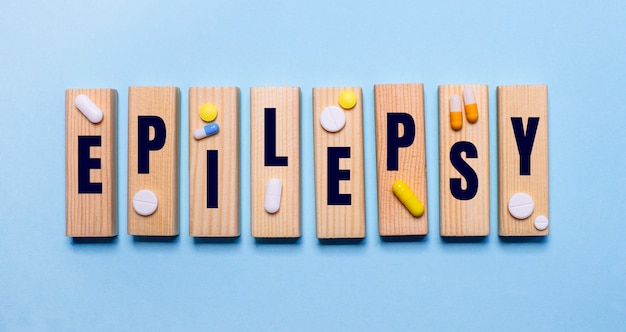 Premium Photo | The word epilepsy is written on wooden blocks on a blue ...