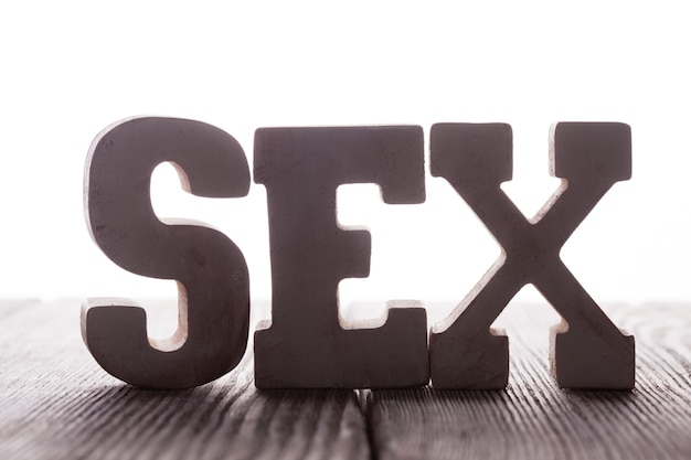 Premium Photo The Word Sex From Wooden Letters Stand On The Table 7329