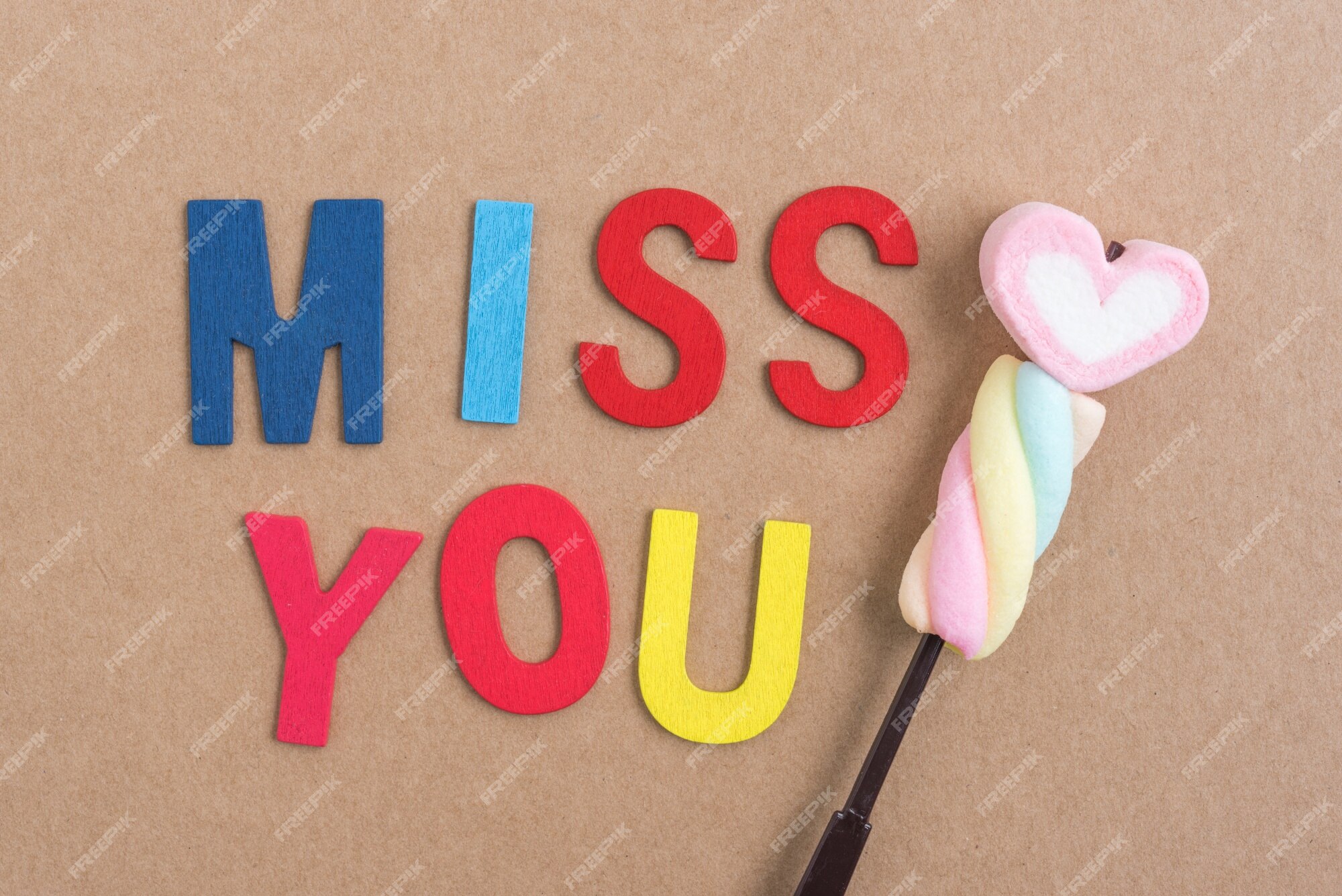 Free Photo | Words miss you with heart candy