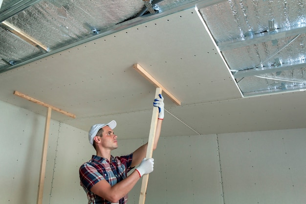 Worker Fixing Suspended Ceiling Photo Premium Download