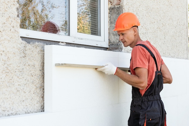 Premium Photo | The worker is checking with an aluminum plaster ruler