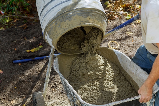Premium Photo | Worker uses a concrete made of in the concrete mixer at