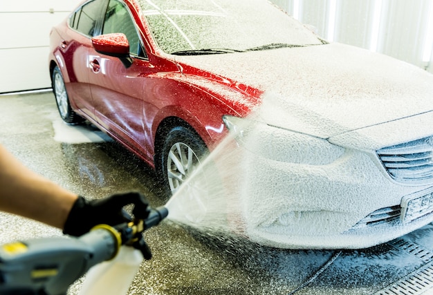 premium photo worker washing car with active foam on a car wash on touchless car wash near me tesla