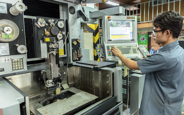 Worker working with cnc machine at workshop Premium Photo