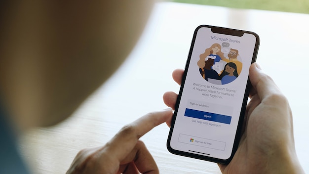 A working from home employee is downloading the microsoft teams social platform, ready for remote working in isolation from home Premium Photo