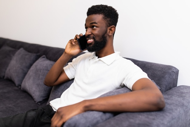 Premium Photo Working At Home Happy African Man Talking At Mobile