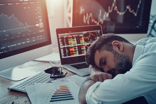 Premium Photo | Working late hours. exhausted young businessman in ...