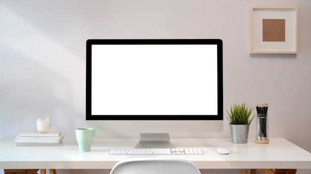 Workplace with blank screen pc comfortable work table. loft desk space Premium Photo