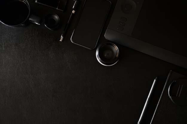 Workspace on black leather top table of a creative designer or photographer and copy space Premium Photo