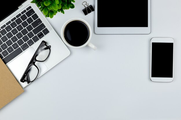 Workspace in office with tablet and with empty blank screens. Premium Photo