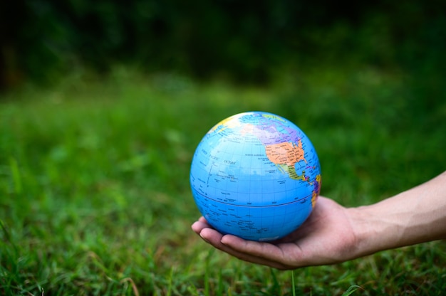 Premium Photo | World environment day .love the world .hand holding a globe