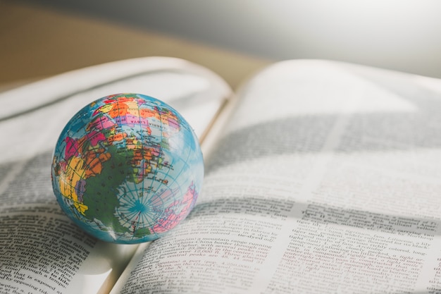 Premium Photo | World globe on book. education school concept