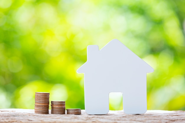 World habitat day,close up picture of a pile of coins and a model house Free Photo