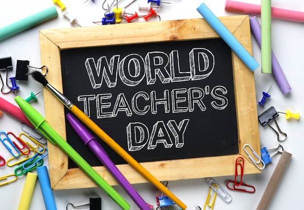 Premium Photo | World teacher's day between school stationary