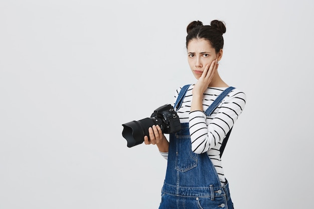 Free Photo | Worried girl photographer feeling nervous. woman holding ...