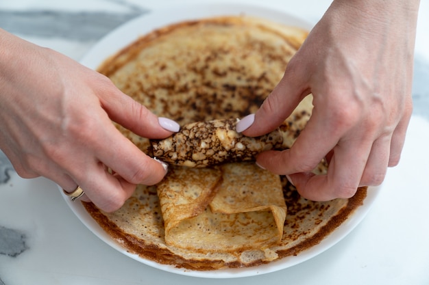 Premium Photo | Wrapping the curd filling into a fried pancake