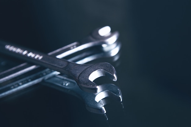 Premium Photo | Wrenches on dark surface