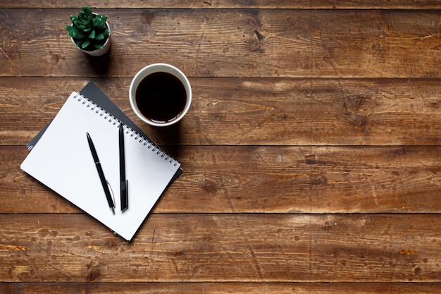 Premium Photo | Written wooden table, on the table a notebook and a ...