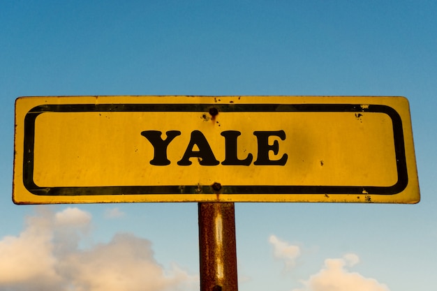 Premium Photo | Yale city street old yellow sign with blue sky