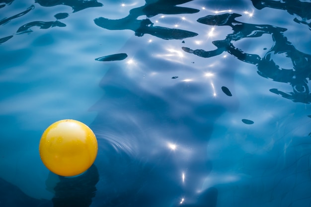 Premium Photo | Yellow balloon in swimming pool