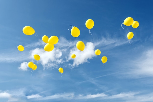 Yellow balloons in blue sky. Photo | Premium Download